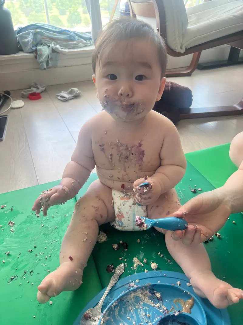 Amadeus at seven months, covered head to toe in purple food